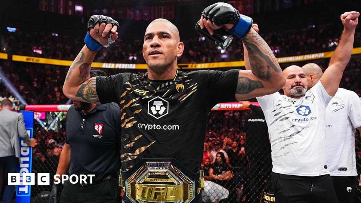 Alex Pereira flexing his biceps with the light-heavyweight UFC title around his waist