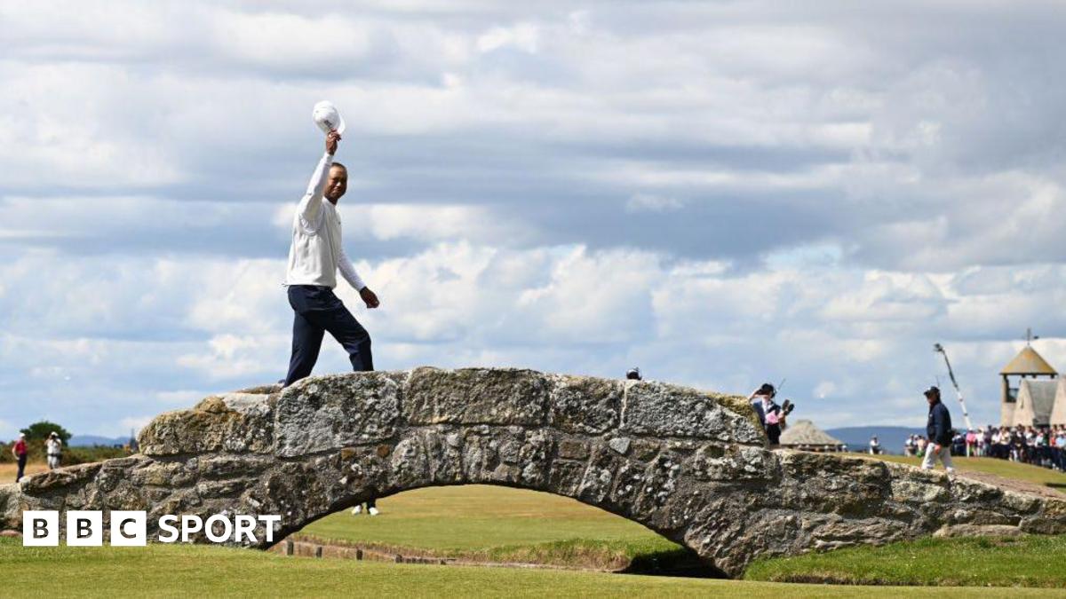 Tiger Woods of the United States acknowledges the crowd on the Swilcan Bridge on the 18th hole during Day Two of The 150th Open at St Andrews Old Course on July 15, 2022 in St Andrews, Scotland.