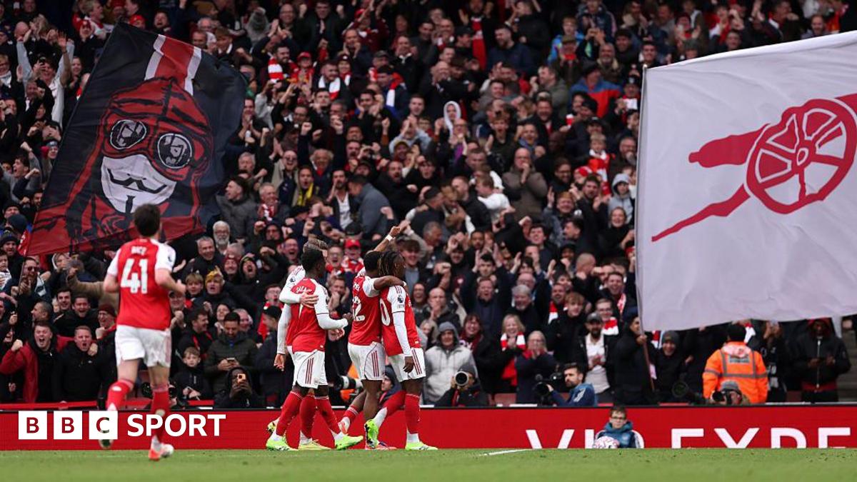 Arsenal players celebrate a goal with supporters