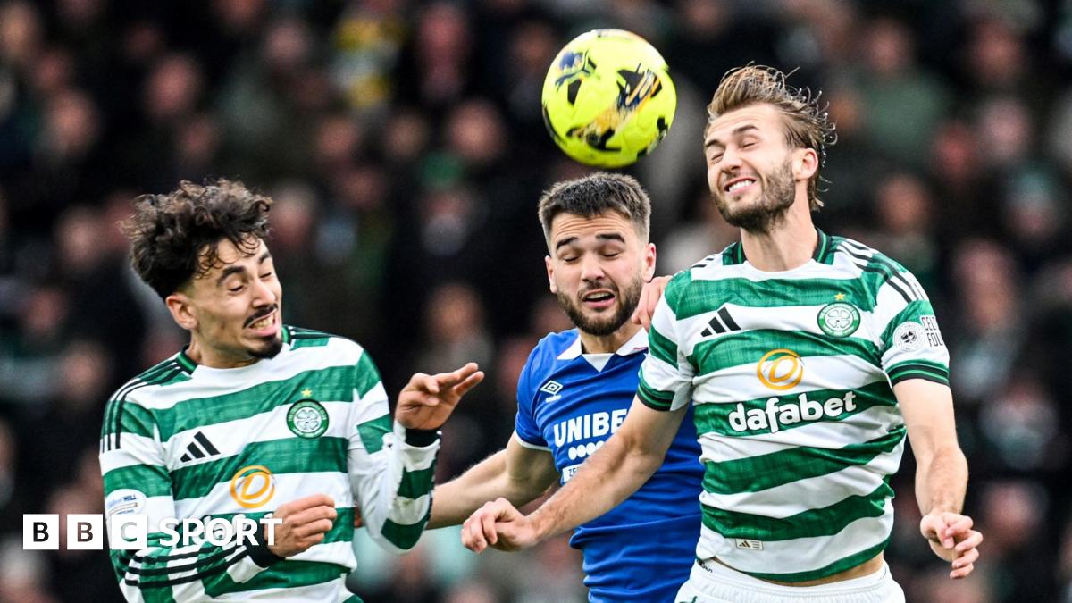 Celtic and Rangers players challenge for the ball