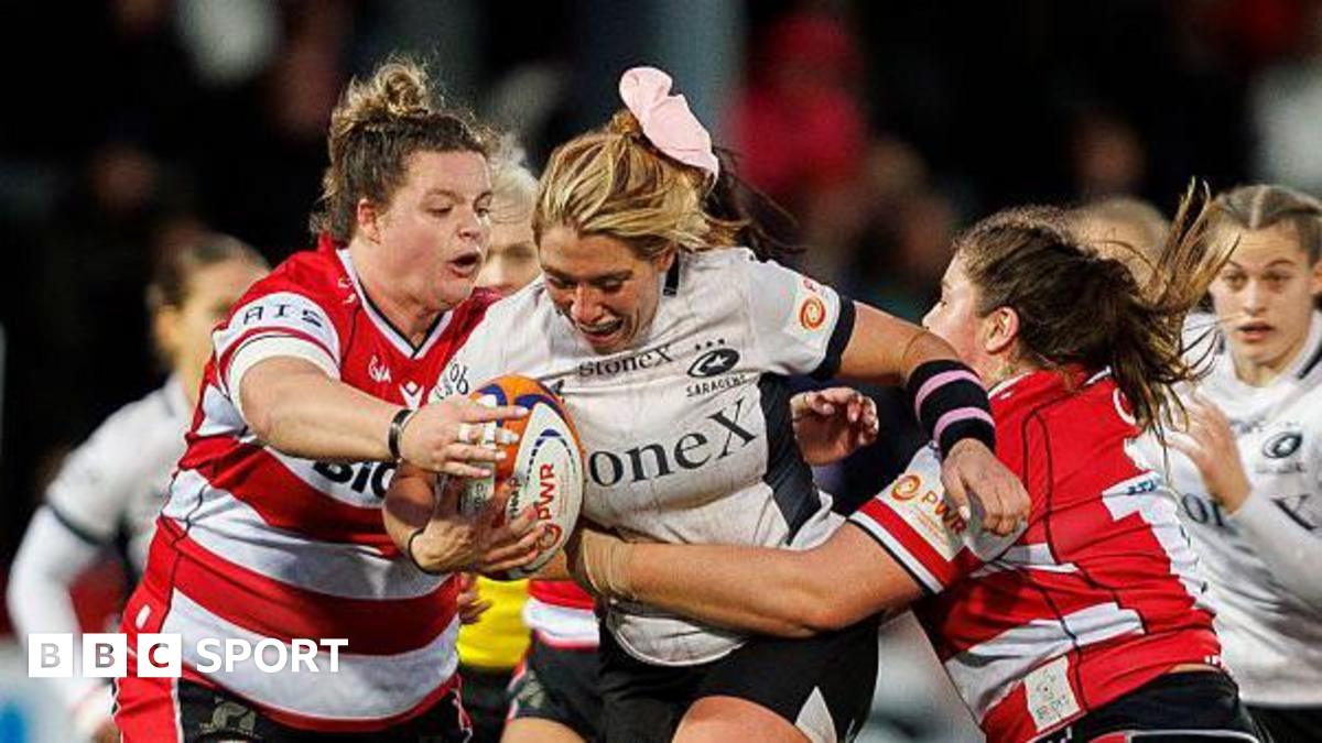 Georgia Evans is hit by a double tackle 