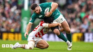 Ireland centre Robbie Henshaw is tackled