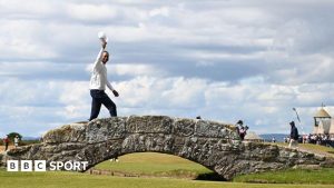 Tiger Woods of the United States acknowledges the crowd on the Swilcan Bridge on the 18th hole during Day Two of The 150th Open at St Andrews Old Course on July 15, 2022 in St Andrews, Scotland.