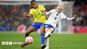 Geyse and Alex Greenwood battle for the ball