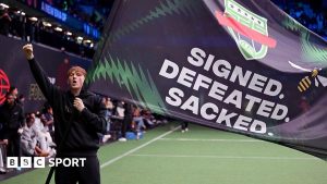 AngryGinge holds a flag that reads
