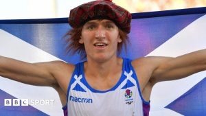 Jake Wightman with a Scottish flag