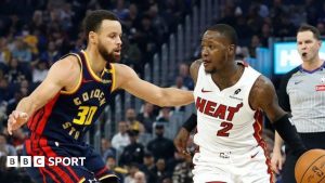 Shai Gilgeous-Alexander #2 of the Oklahoma City Thunder dribbles the ball while defended by Aaron Nesmith #23 of the Indiana Pacers