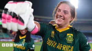 Nadine de Klerk fist-pumps a team-mate with a smile on her face