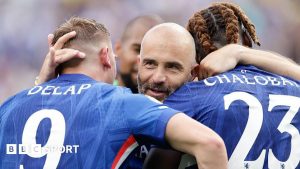 Chelsea manager Enzo Maresca hugs Liam Delap and Trevoh Chalobah after winning the Club World Cup