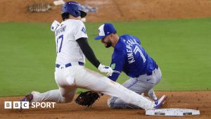 Los Angeles Dodgers designated hitter Shohei Ohtani is tagged out by Isiah Kiner-Falefa while attempting to steal second base in the ninth inning