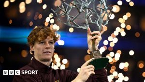 Jannik Sinner lifts the tree-shaped Paris Masters trophy