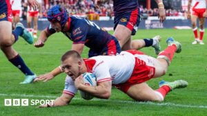 Hull KR player Mikey Lewis dives over the line to score a 