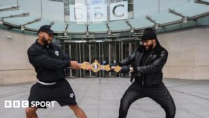 Frazer Clarke and Jeamie TKV play tug of war with the British heavyweight title